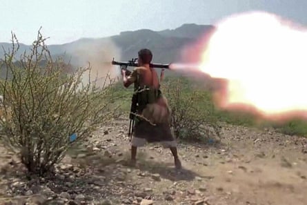 A man firing a rocket-propelled grenade