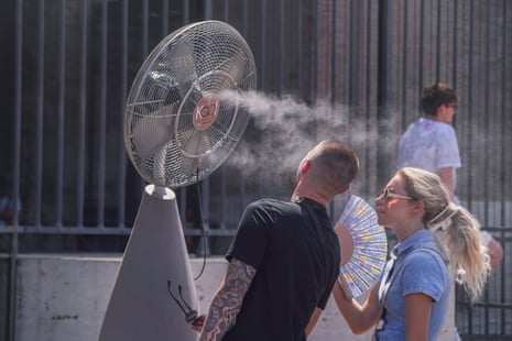 Tourists at the colosseum in Rome are sprayed with cooling mist to escape the heat.