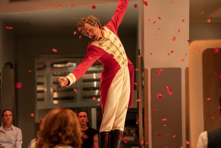 Actor Neil Patrick Harris is shown dressed as a drum majorette sprinkling petals throughout Unit’s HQ.