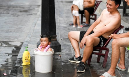 An infant tries to cool off in Hunan province