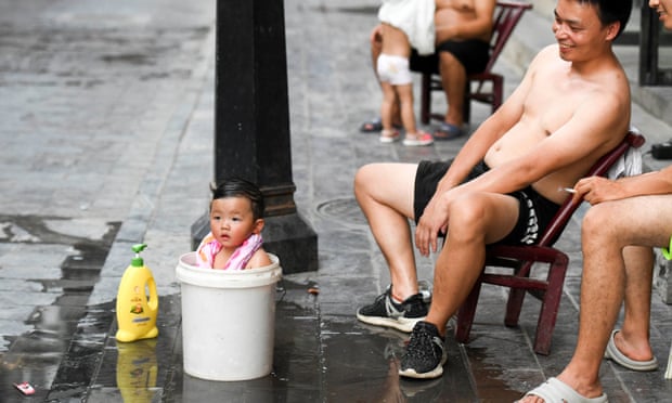 An infant tried to cool off during a heatwave in Hunan province, China.