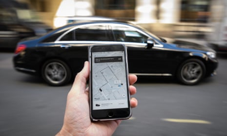 A phone displays the Uber ride-hailing app in London