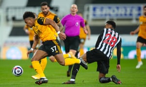 Wolves’ Adama Traore goes past Joe Willock of Newcastle United.