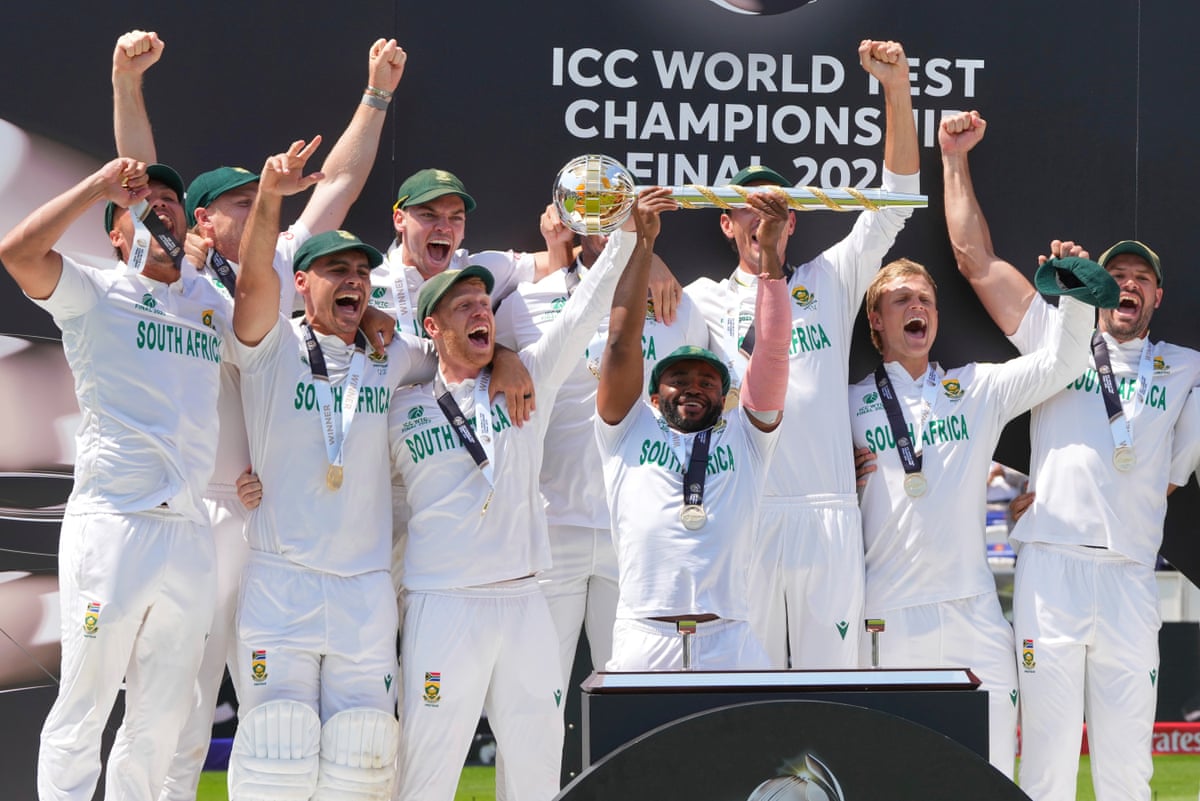 South Africa’s Test captain, Temba Bavuma, holds the winner’s trophy and celebrates with teammates on the podium after their win in the World Test Championship against Australia at Lord’s