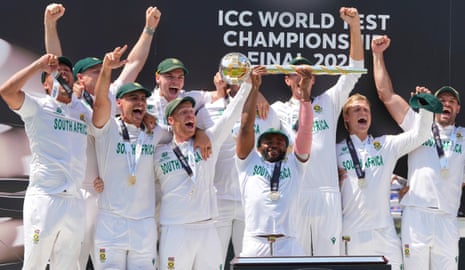 South Africa captain Temba Bavuma (centre) lifts the World Test Championship trophy alongside his celebrating teammates.