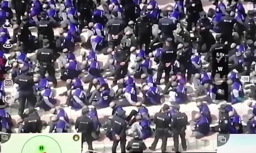 A video screengrab shows bound and blindfolded Uighur men at a railway station in south-east Xinjiang, China, in August 2018.