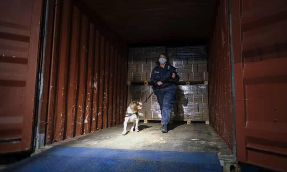 A police officer with a sniffer dog conducting a serach