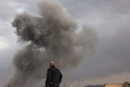 A man looks on in Tehran amid the US-Israeli bombardment