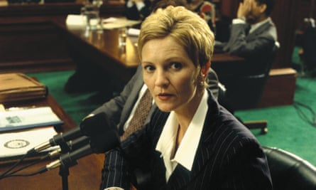 a woman in a suit looks to her left