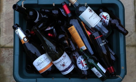 Empty bottles of alcohol are seen in a recycling box