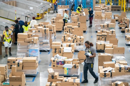 Workers sort packages by zip code during a media tour of the Amazon AGS5 facility on in Appling, Georgia, on October 27, 2022.