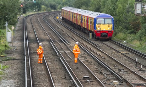 A train passes track workers