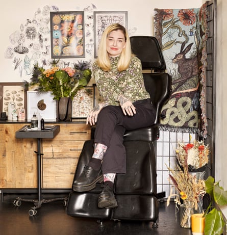 Rebecca Vincent in her studio, surrounded by floral tattoo artwork
