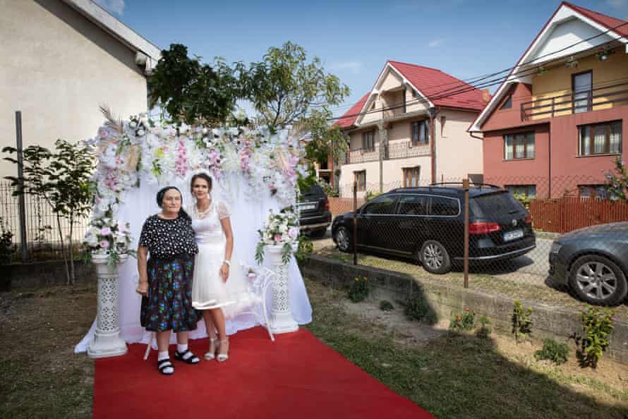 Jesica Monica Bura poses for a portrait in front of her parents' house