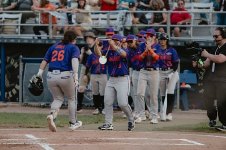 Players cheer after one of their own hits a home run