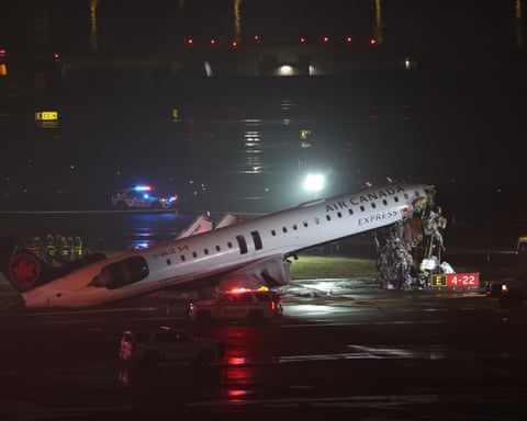 An Air Canada Express CRJ-900 sits on the runway after colliding with a Port Authority fire truck at LaGuardia Airport in New York
