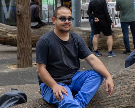 Adrian Stan sitting on a log bench
