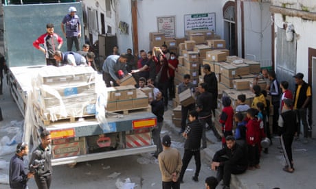 People unloading boxes from the back of a lorry