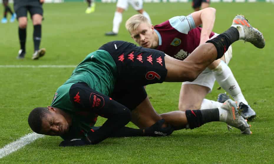 Wesley of Aston Villa suffers his knee injury at Burnley.