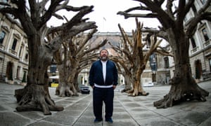 Ai Weiwei pictured in London, 2015, with his creation named Tree