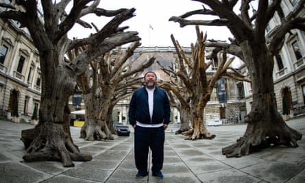 Ai Weiwei pictured in London, 2015, with his creation named Tree