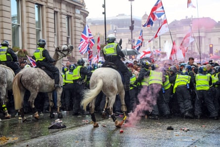 Flares being thrown as people taking part in a ‘unite the kingdom’ rally were held back by police in London on Saturday.