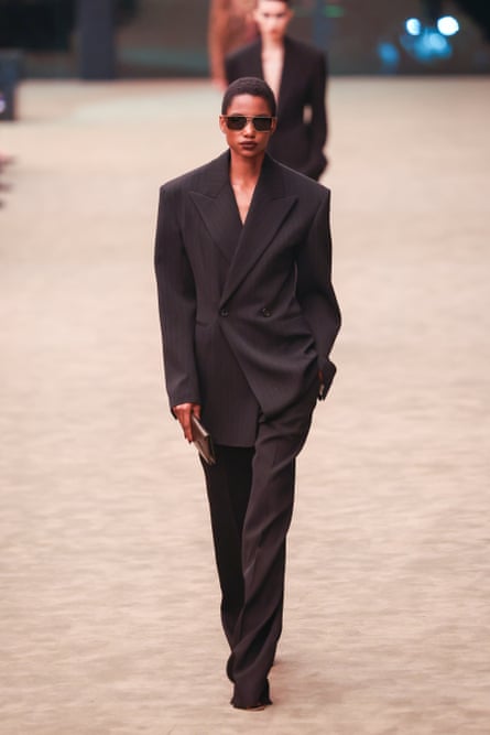 A model walks the runway in a black suit