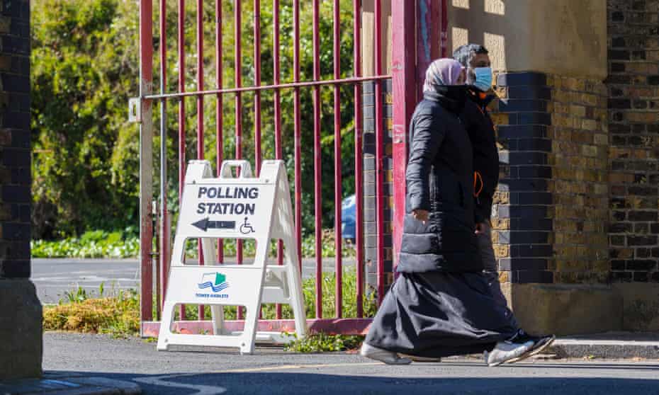 People leave a polling station in Tower Hamlets, London. 