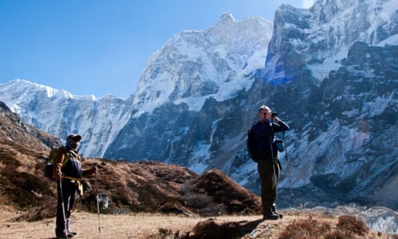 A trekker and guide admiring the Mt Jannu massif in background, Kumbhakarna valley.