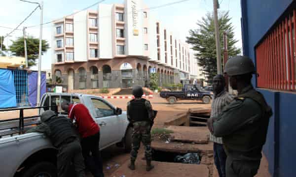 Malian policemen and security officials guard the Radisson hotel