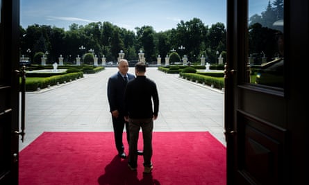 Viktor Orban and Volodymyr Zelenskiy standing on a red carpet in a doorway in Kyiv