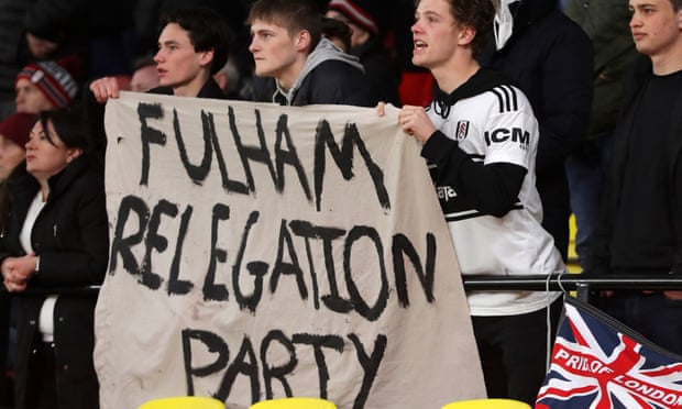 Fulham fans try to keep their spirits up at Vicarage Road.