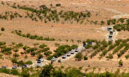 Vehicles make their way through Lebanon as part of the repatriation