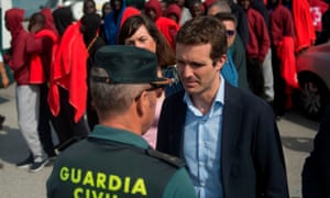 PP party leader Pablo Casado speaks to a member of the Spanish Civil Guard during a visit to the harbour of Algeciras.