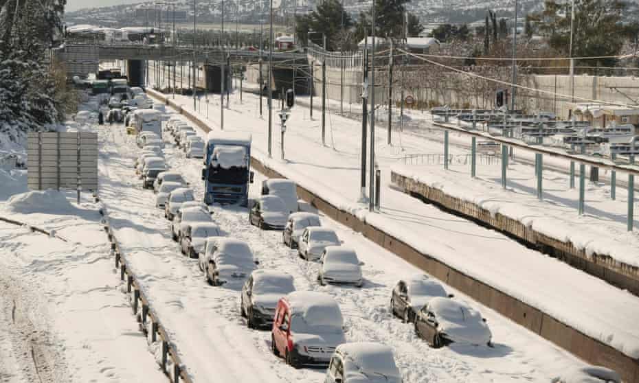 Abandoned vehicles covered in snow in Athens on Tuesday