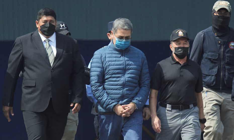 Juan Orlando Hernández at Tegucigalpa airport on 21 April as he is taken to a plane to be extradited to the US.
