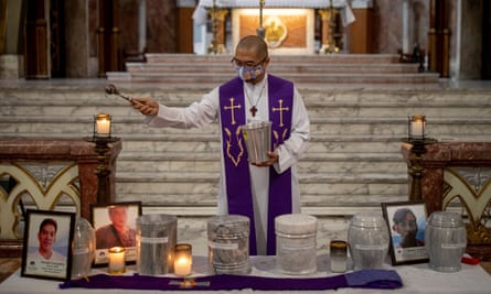 The Catholic priest Father Flaviano Villanueva blesses the urns of drug war victims during a ceremony for their families in a church in Manila, Philippines, in 2021.