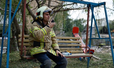 A rescue worker uses walkie talkie during search-and-rescue operations on 8 August 2023 in Pokrovsk, Ukraine.