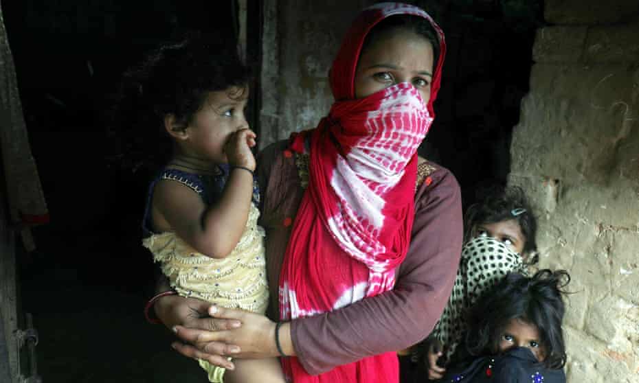 A woman and children wait for TB screening at Jakhada village, north India.