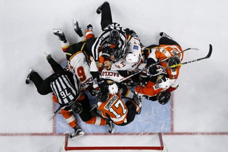 Referees try to break up a fight between the Philadelphia Flyers and the Calgary Flames.