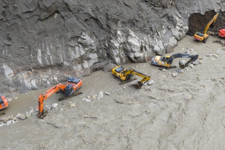 Excavators repairing a section of damaged road to restore access to Gyirong Port