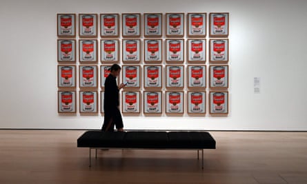 A woman walks past Campbell’s Soup Cans by Andy Warhol during a press preview on 10 October.