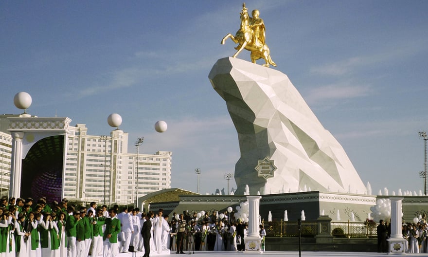 People gather in Ashgabat for the unveiling of a gold-leaf statue of president Gurbanguly Berdymukhamedov atop a horse.