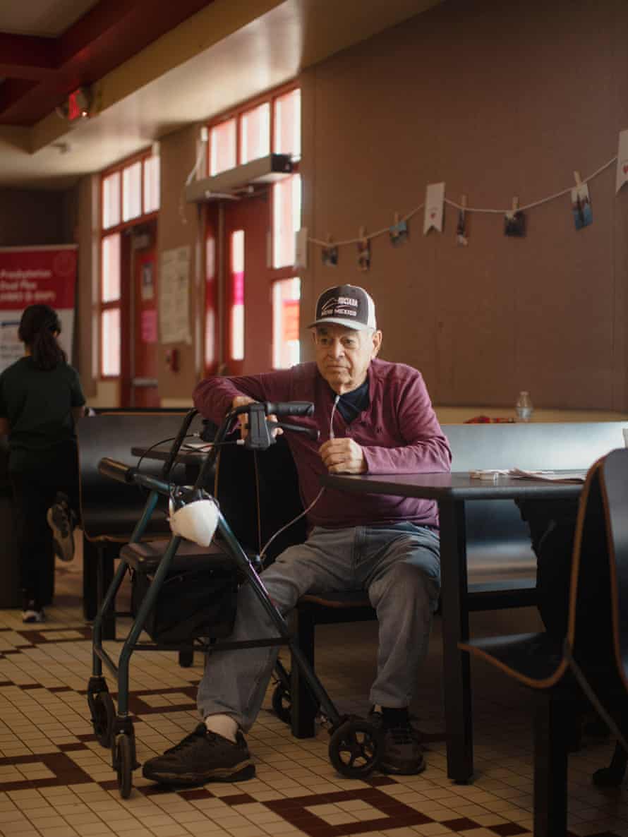 Man sits at table with walker