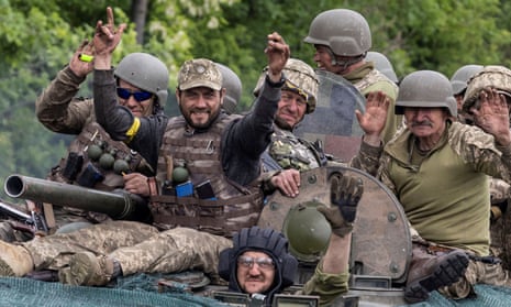 Ukrainian service members ride on military vehicle on the road between Kostiantynivka and Bakhmut, Donetsk region.