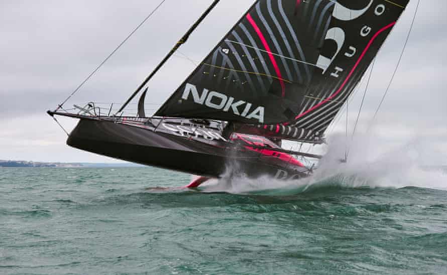 Thomson helms the Hugo Boss IMOCA 60 during a training session.