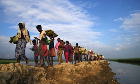 Rohingya Muslim refugees who were stranded after leaving Myanmar walk towards the Balukhali refugee camp