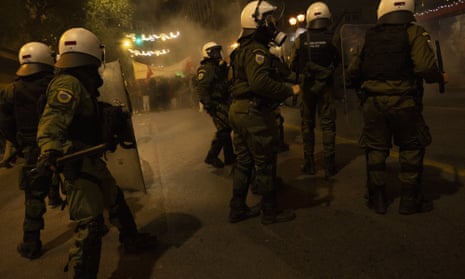 Riot police in Athens try to disperse demonstrators during a protest rally following the death of the teenager.