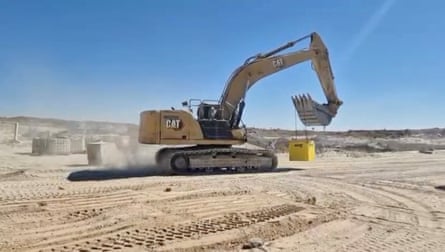 A vehicle moving a yellow brick
