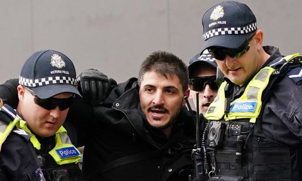 Fanos Panayides is detained by police at an anti-lockdown protest outside Parliament House in Melbourne on 10 May.
